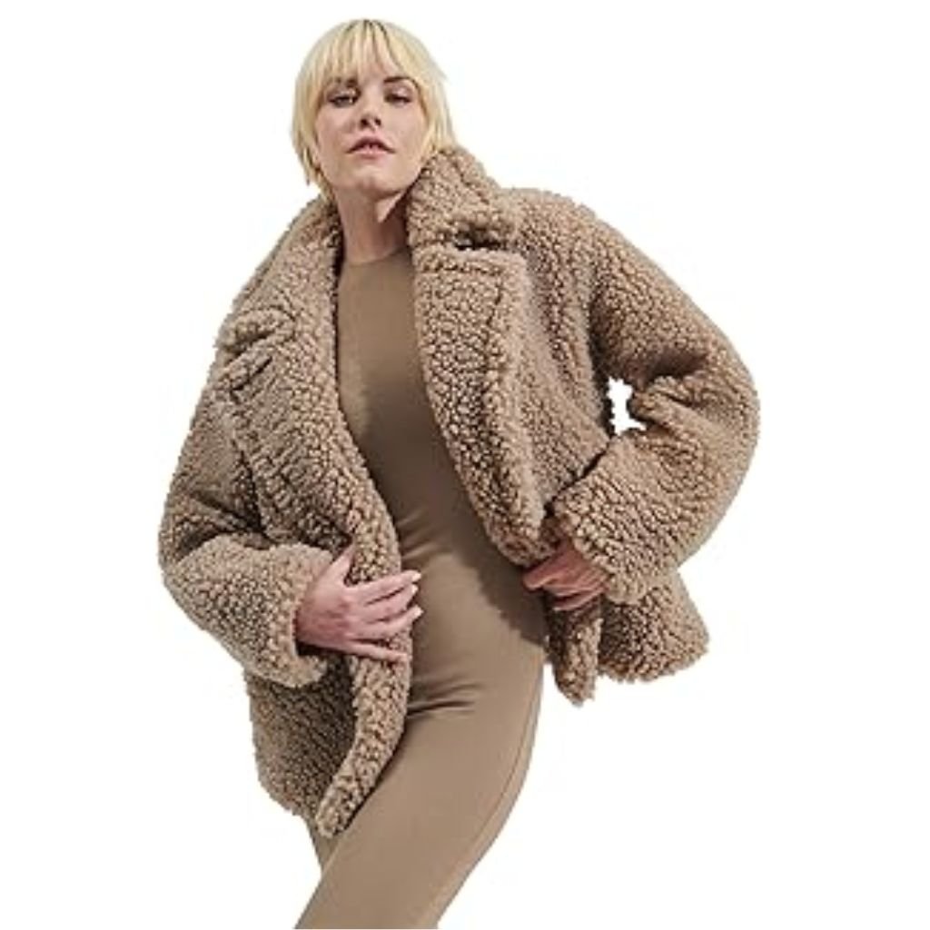 A woman wearing a brown double-breasted wool coat with a wide collar, styled with patterned black leggings.Teddy Coats