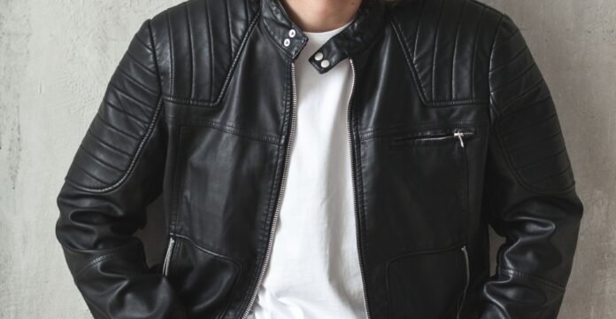 A black zip-up leather jacket worn over a white T-shirt.