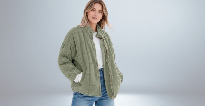 A woman wearing an oversized olive-green quilted cozy jacket with large pockets, standing against a neutral background.