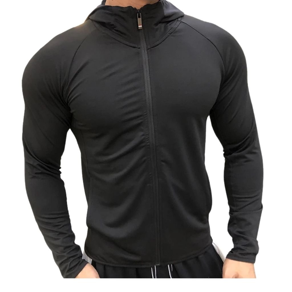 A muscular man wearing a form-fitting black zip-up gym jacket with a high collar, long sleeves, and a front vertical zipper.