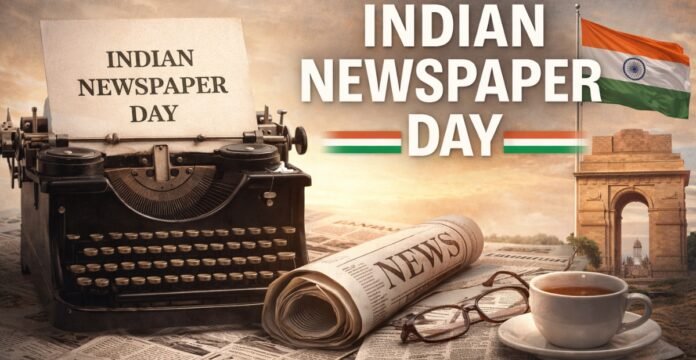 A vintage scene celebrating Indian Newspaper Day: a classic typewriter with a sheet reading “INDIAN NEWSPAPER DAY,” a rolled newspaper labeled “NEWS,” reading glasses, and a cup of tea on a stack of newspapers. In the background, the Indian flag waves near the India Gate monument.