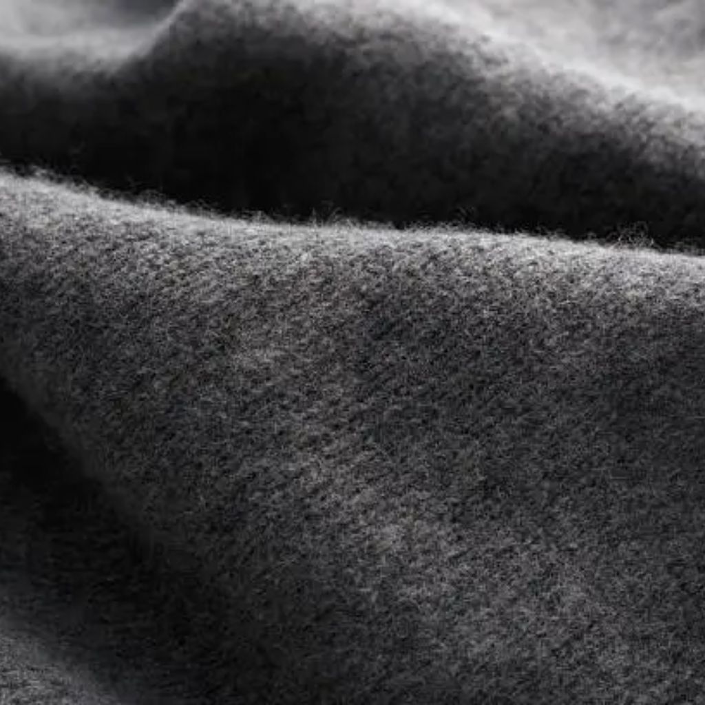 “Close-up black-and-white photo of soft, textured wool fabric with a fuzzy surface.”
High-Density Wool Fabric: