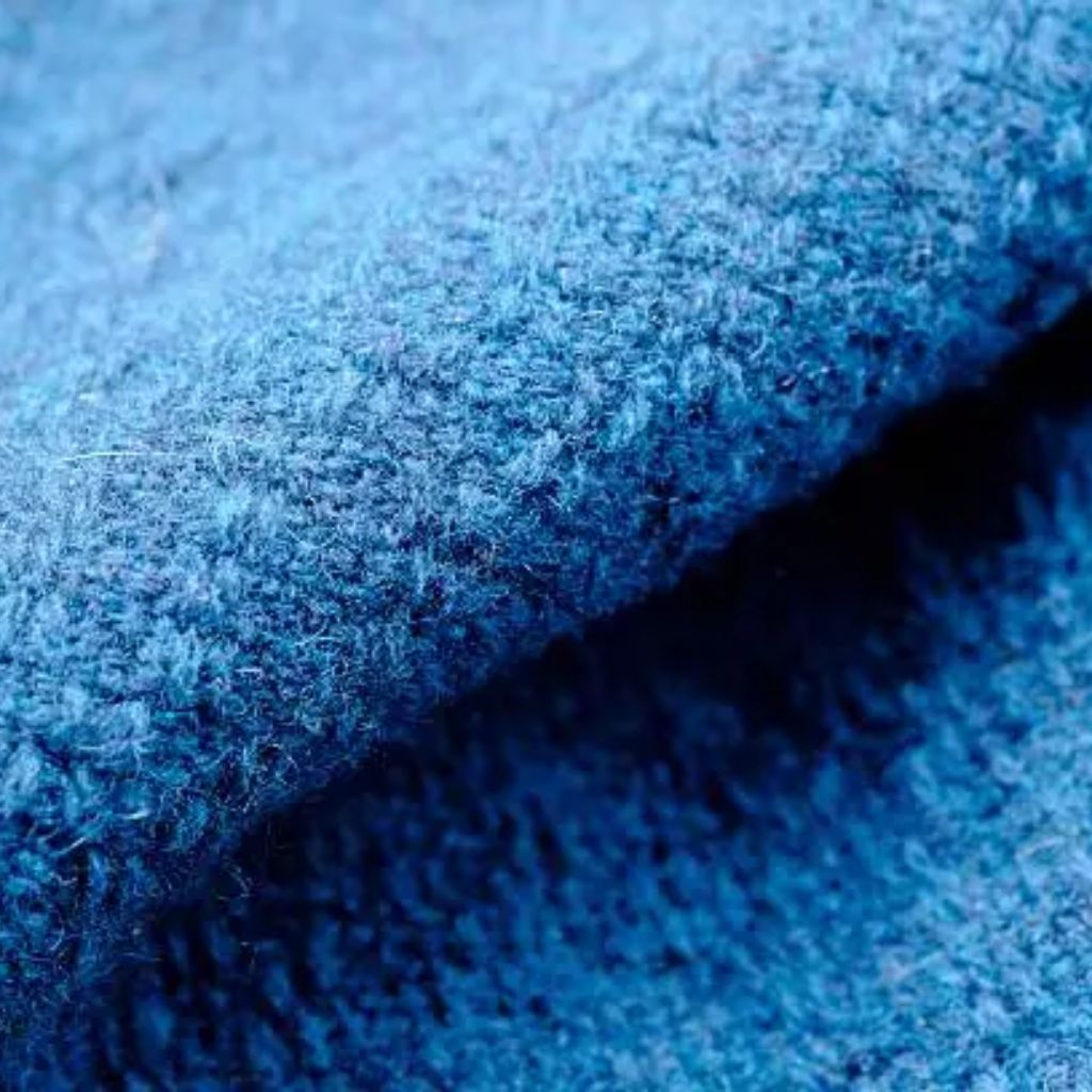 “Close-up of bright blue fuzzy fabric with a soft, plush texture.”
High-Density Wool Fabric:
