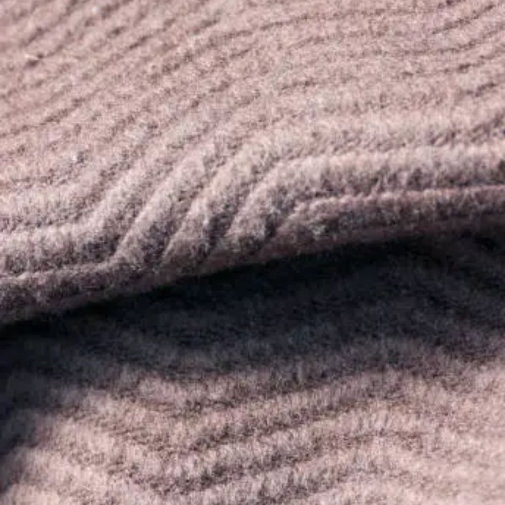 “Close-up photo of soft, pinkish-beige velvet or chenille fabric with a plush, ribbed texture.”
High-Density Wool Fabric: