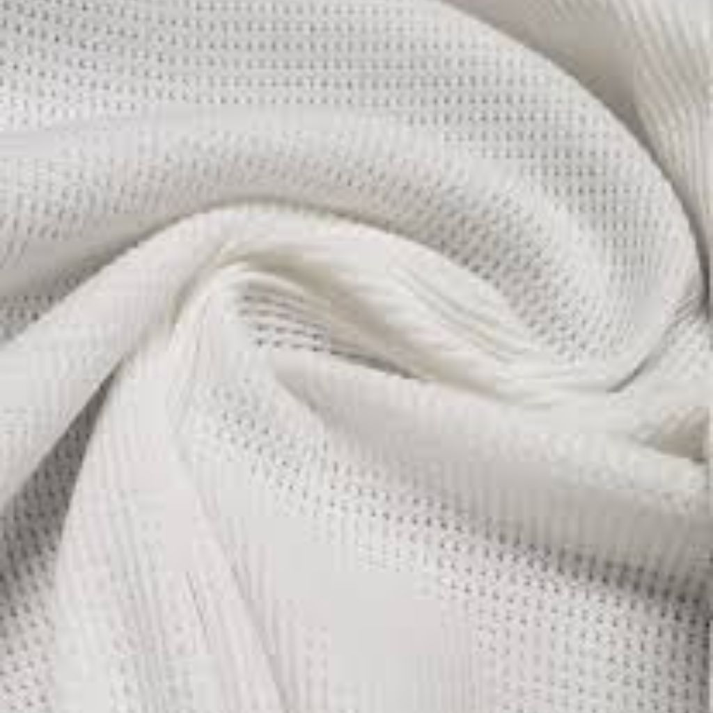 What Is Thermal Fabric? Features, Uses, and Buying Tips 12 Close-up of a white or light-gray textured fabric with a knotted or twisted fold, showing a woven or mesh-like pattern.”What Is Thermal Fabric?