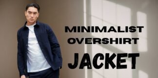 Minimalist Overshirt Jacket: Clean Style for Modern Wear A man wearing a navy minimalist overshirt and white tee stands against a neutral wall.