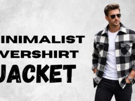 A stylish man wearing a black-and-white checkered overshirt jacket over a white T-shirt and black pants, standing against a gray concrete wall. The large bold text on the left reads MINIMALIST OVERSHIRT JACKET.
