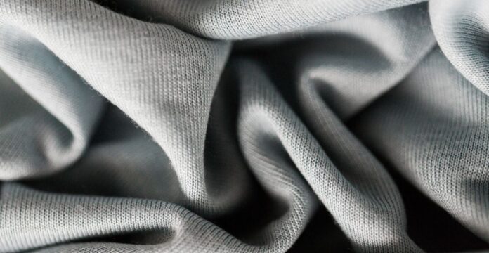 Organic Made Cashmere Wool Fabric A close-up view of soft, gray fabric folds and textures.Organic Made Cashmere Wool Fabric