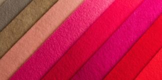 Pashmina Cashmere Wool Fabric Guide to Timeless Elegance A diagonal arrangement of overlapping colorful felt strips in shades of brown, peach, pink, magenta, and red.
