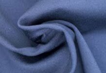 Moisture-Wicking Winter Fabric Explained: Benefits & Uses A close-up view of a soft blue fabric folded and twisted to show its texture and drape. Moisture-Wicking Winter Fabric Explained: