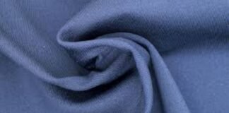 Moisture-Wicking Winter Fabric Explained: Benefits & Uses A close-up view of a soft blue fabric folded and twisted to show its texture and drape. Moisture-Wicking Winter Fabric Explained: