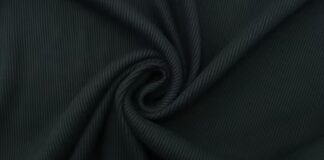 Premium Tweed Fabric: Timeless Elegance Meets Modern Style Close-up of dark, ribbed fabric twisted in a swirl pattern. Premium Tweed Fabric: