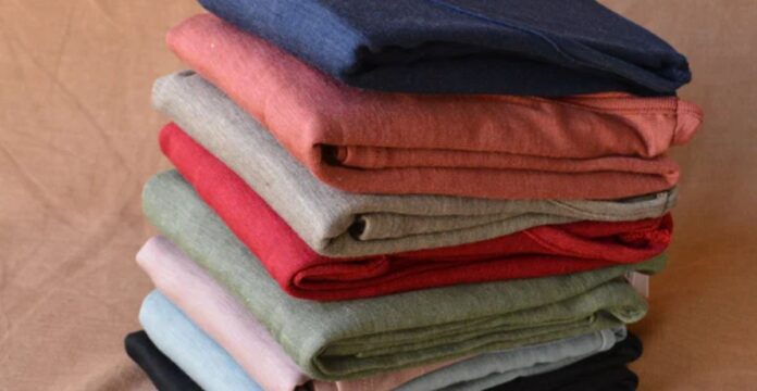 “Stack of folded sweaters in various colors arranged on a surface.”Wool Thermal Fabric Explained: