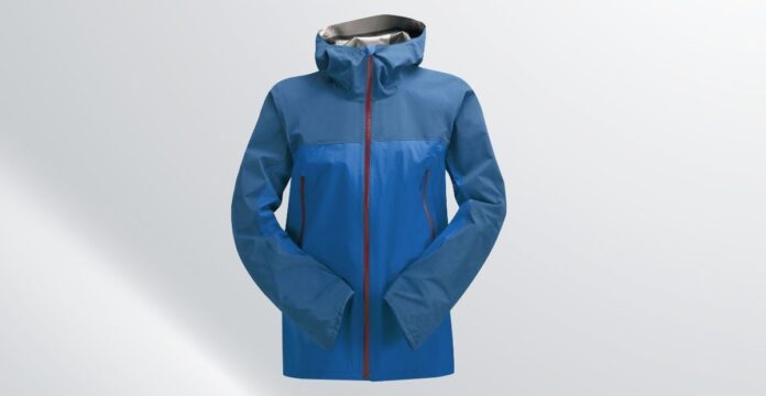 A blue men’s storm jacket with a high collar and red zipper, standing against a light background.