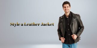 How to Style a Leather Jacket: Classic Looks for Every Season A smiling man wearing a black leather jacket over a dark shirt and jeans, posing confidently against a light gray background. The text “Style a Leather Jacket” appears in gold lettering.