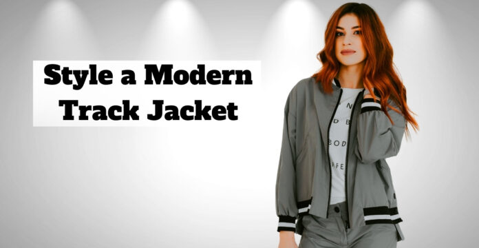 A woman wearing a modern gray track jacket stands against a light gray background with spotlights; bold text on the left reads 'Style a Modern Track Jacket.