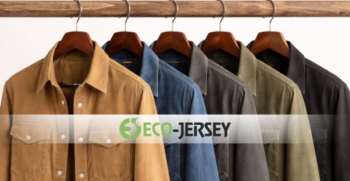 A row of button-down shirts in earth tones and denim hanging on a rack with a translucent banner reading 'ECO-JERSEY' across the middle.