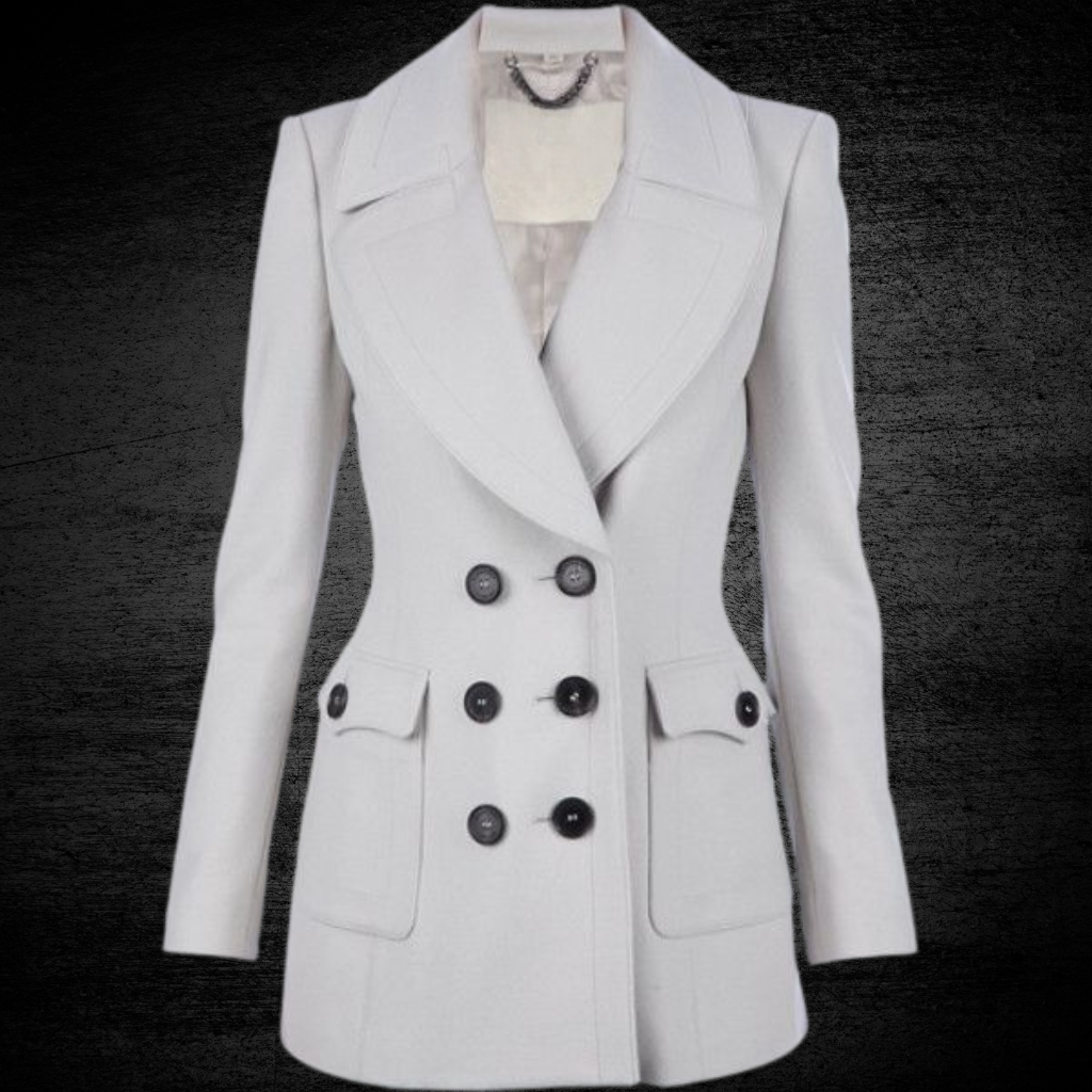 Light gray double-breasted blazer with wide lapels, six buttons, and flap pockets displayed on a dark background.