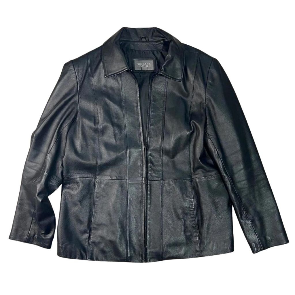 A black leather jacket with a classic collar and front zipper, featuring panel stitching and long sleeves on a white background.Wilson Leather Jacket