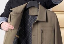 Winter Overshirt Jackets: The Perfect Cold-Weather Layer A person holding up an olive-brown jacket, showing the coat’s interior lining and a zippered chest pocket.