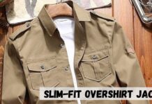 Slim-Fit Overshirt Jacket: Modern Style & Everyday Comfort A khaki slim-fit overshirt jacket placed on a wooden surface with a white shirt underneath. The jacket has two chest pockets with flaps and button closures, shoulder epaulets, and a small patch on the left sleeve.