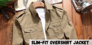 Slim-Fit Overshirt Jacket: Modern Style & Everyday Comfort A khaki slim-fit overshirt jacket placed on a wooden surface with a white shirt underneath. The jacket has two chest pockets with flaps and button closures, shoulder epaulets, and a small patch on the left sleeve.