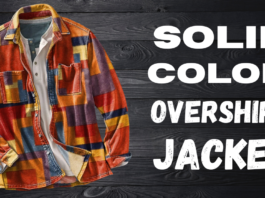 Colorful solid-color overshirt jacket with a patchwork pattern laid over a dark wooden background.