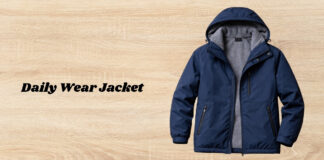 Daily Wear Jacket That Combines Comfort Style and Everyday Ease Navy blue hooded jacket with gray fleece lining, displayed on a light wooden surface.