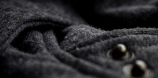 Double-Faced Cashmere Fabric: Luxury and Style Guide Double-Faced Cashmere Fabric Close-up of dark gray cashmere/wool fabric with a soft, textured surface; two metal fasteners on the right side are out of focus.