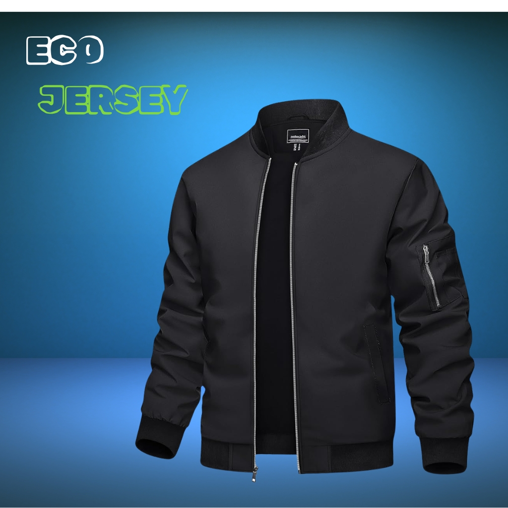 Studio shot of a black bomber jacket against a blue gradient background. The jacket is zipped with ribbed cuffs and hem, and features a zippered sleeve pocket on the left arm."