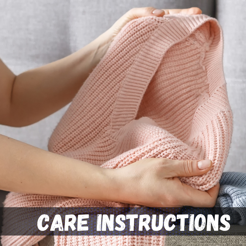 Close-up of a person holding a pink knitted sweater, showing the folded fabric and texture