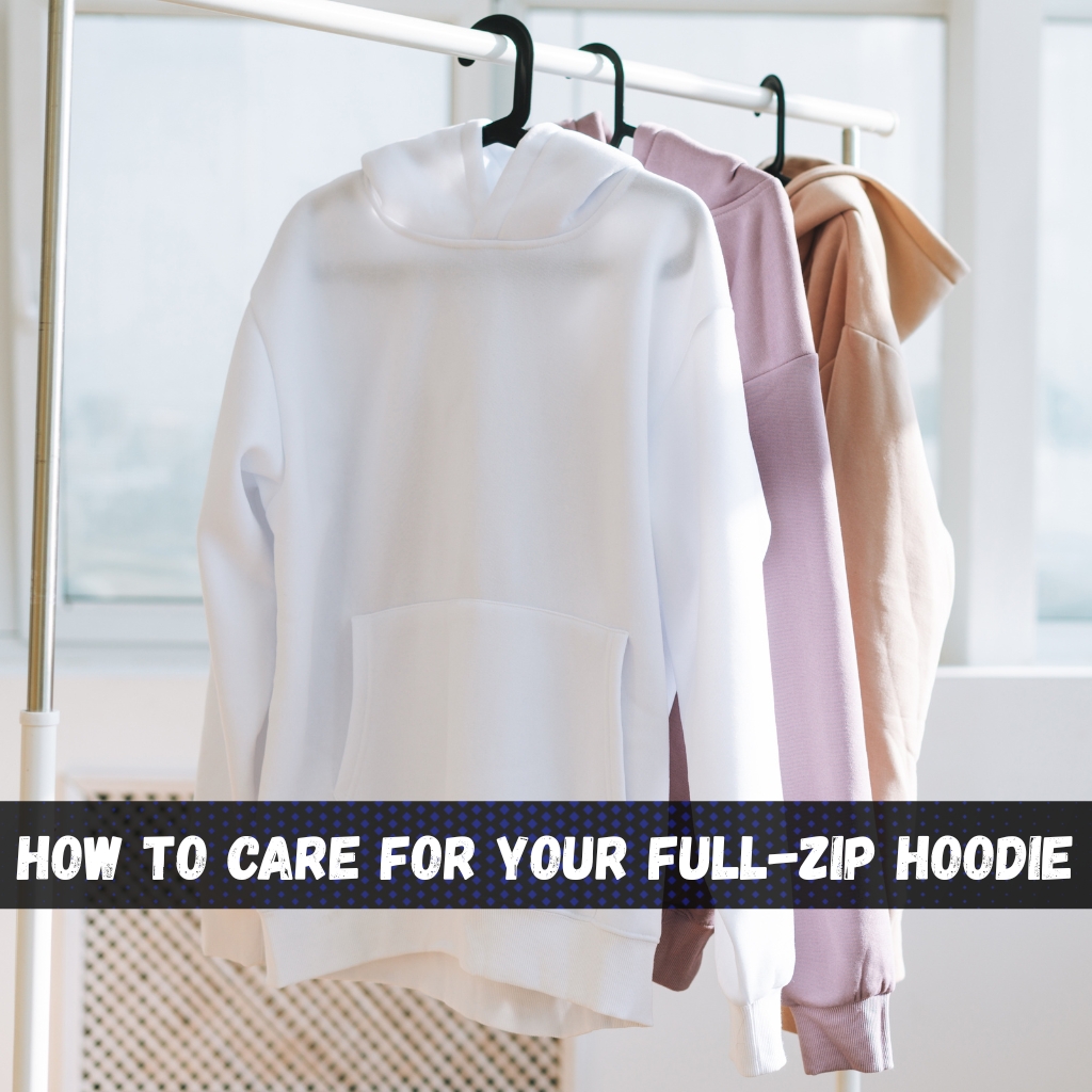 Ultimate Guide to Full-Zip Hoodies: Styles, Tips & Trends 3 Three hoodies in white, light purple, and tan hang on black hangers from a white clothing rack near a window with blinds. full-zip hoodie