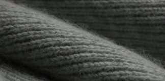 Knit Pure Cashmere Fabric: Luxury & Warmth Guide Knit Pure Cashmere Fabric Close-up of a gray knitted cashmere fabric, showing textured ridges and fibers with soft, diffuse lighting.