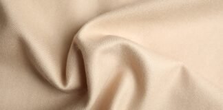 Lightweight Grade B Cashmere Fabric Luxury Guide Lightweight Grade B Cashmere Fabric Close-up of beige cashmere fabric with soft folds and draped texture.