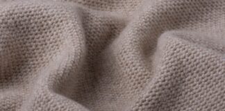 Lightweight Pure Cashmere Fabric Benefits Guide Lightweight Pure Cashmere Fabric Close-up of a lightweight, light-brown knitted cashmere fabric with a dense, uniform knit pattern and soft folds.