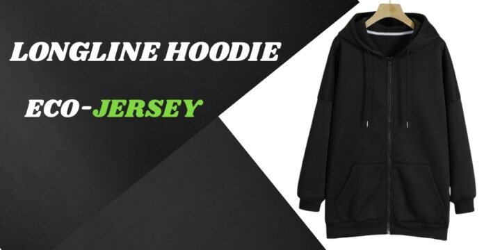 A black longline hoodie hanging on a wooden rack against a dark geometric backdrop.