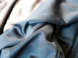 Close-up of folded blue-grey fabric with soft texture and visible seam on the right; light-to-dark color gradient.What Is Cryo Comfort Winter Fabric?