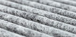 Heat Trap Insulation Fabric: Advanced Warmth for Winter Wear Alt text: "Close-up of white fibrous air filter material arranged in parallel rows with a shallow depth of field." Heat Trap Insulation Fabric: