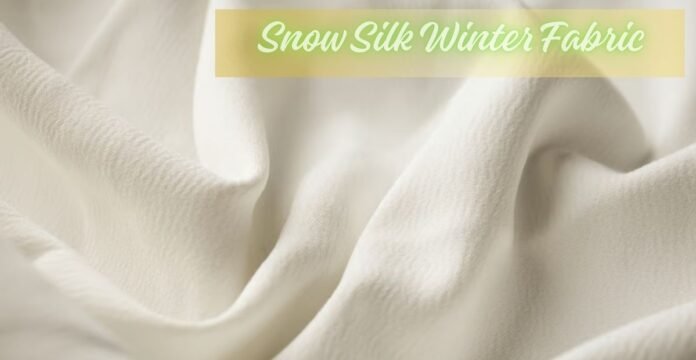 Alt text (short, screen-reader friendly): Close-up of creamy white, luxurious fabric draped in soft folds with highlights and shadows; a yellow banner overlays the top. Snow Silk Winter Fabric: