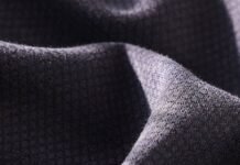 What Is Thermal Core Elite Fabric? Features, Benefits & Uses Alt text: Close-up of textured, folded fabric in dark gray with a rough surface; light highlights the peaks and shadows in the folds. What Is Thermal Core Elite Fabric?