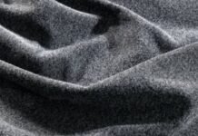 What Is Winter Lock Performance Fabric? Features & Benefits Alt text: Close-up of draped, soft grey wool fabric with a densely textured surface and gentle folds. What Is Winter Lock Performance Fabric?