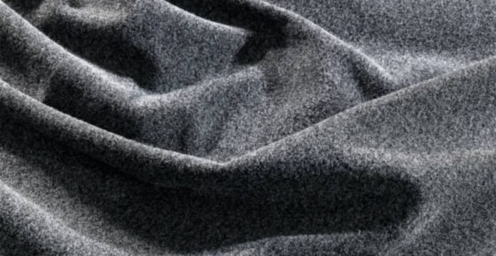 Alt text: Close-up of draped, soft grey wool fabric with a densely textured surface and gentle folds. What Is Winter Lock Performance Fabric?