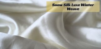 Snow Silk Luxe Winter Weave: Softness Meets Superior Warmth Alt text: Close-up of off-white silky fabric folded into soft curves with subtle shadows; a translucent yellow banner at the top overlays the image with bold text. Snow Silk Luxe Winter Weave: