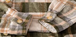 Sherpa Lined Fabric Guide: Features, Advantages & Best Uses Close-up of a plaid winter shirt or coat sleeve with beige buttons, showing soft, flannel-like fabric in green, orange, cream tones. Sherpa Lined Fabric Guide: