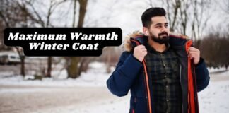 Maximum Warmth Winter Coat Explained: Features & Benefits Alt text: A man outdoors in a snowy setting wearing a navy winter coat with a fur-lined hood. He is holding the coat open to reveal an orange lining and wearing a green plaid shirt underneath. Maximum Warmth Winter Coat Explained: