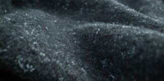 Winter Shield Active Fabric: Warm, Dry & Active Wear Guide Alt text: Close-up of dark, textured fabric likely from a heavy winter coat, showing a fuzzy, felt-like surface. Winter Shield Active Fabric: