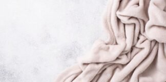 Cloud Fleece Winter Fabric: The Ultimate Soft & Warm Choice Alt text (short, descriptive): A pale pink plush blanket draped in soft folds against a light gray speckled background. Cloud Fleece Winter Fabric:Cloud Fleece Winter Fabric: