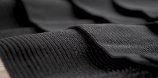 What Is Thermo Guard Pro Fabric? Features, Benefits & Uses Alt text: Close-up of dark gray fabric with a ribbed, corded weave; some areas in sharp focus with subtle shadows, conveying depth. What Is Thermo Guard Pro Fabric?