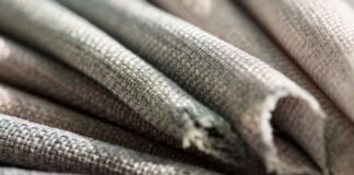 Heat-Retaining Fabric Explained: Maximum Warmth,Less Weight Close-up of folded woven fabric in gray and beige tones, showing a clear weave texture and soft lighting that highlights depth. Heat-Retaining Fabric Explained: