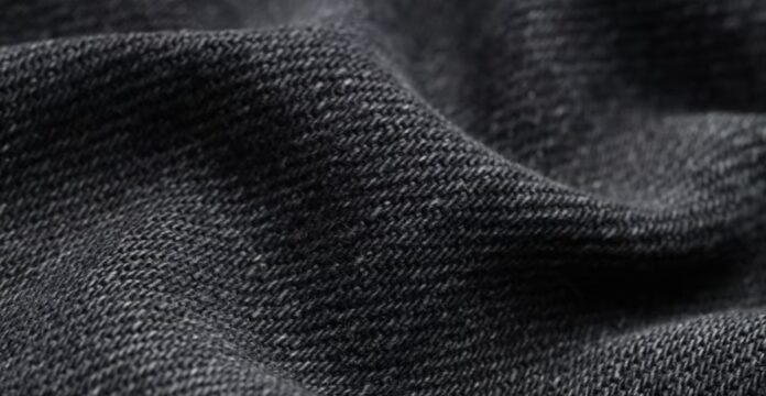 Alt text: Close-up of textured gray fabric with a subtle sheen, showing a pronounced weave and soft folds. ThermoCore HeatLock Fabric: